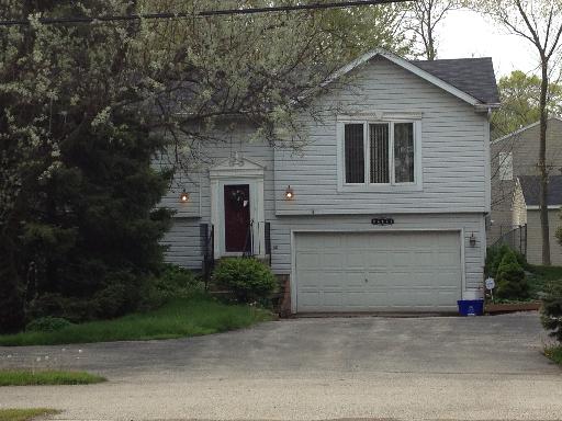 26157 West Rollins Road Ingleside, IL 60041 - Photo 1 of 10 a front view of house with a garden