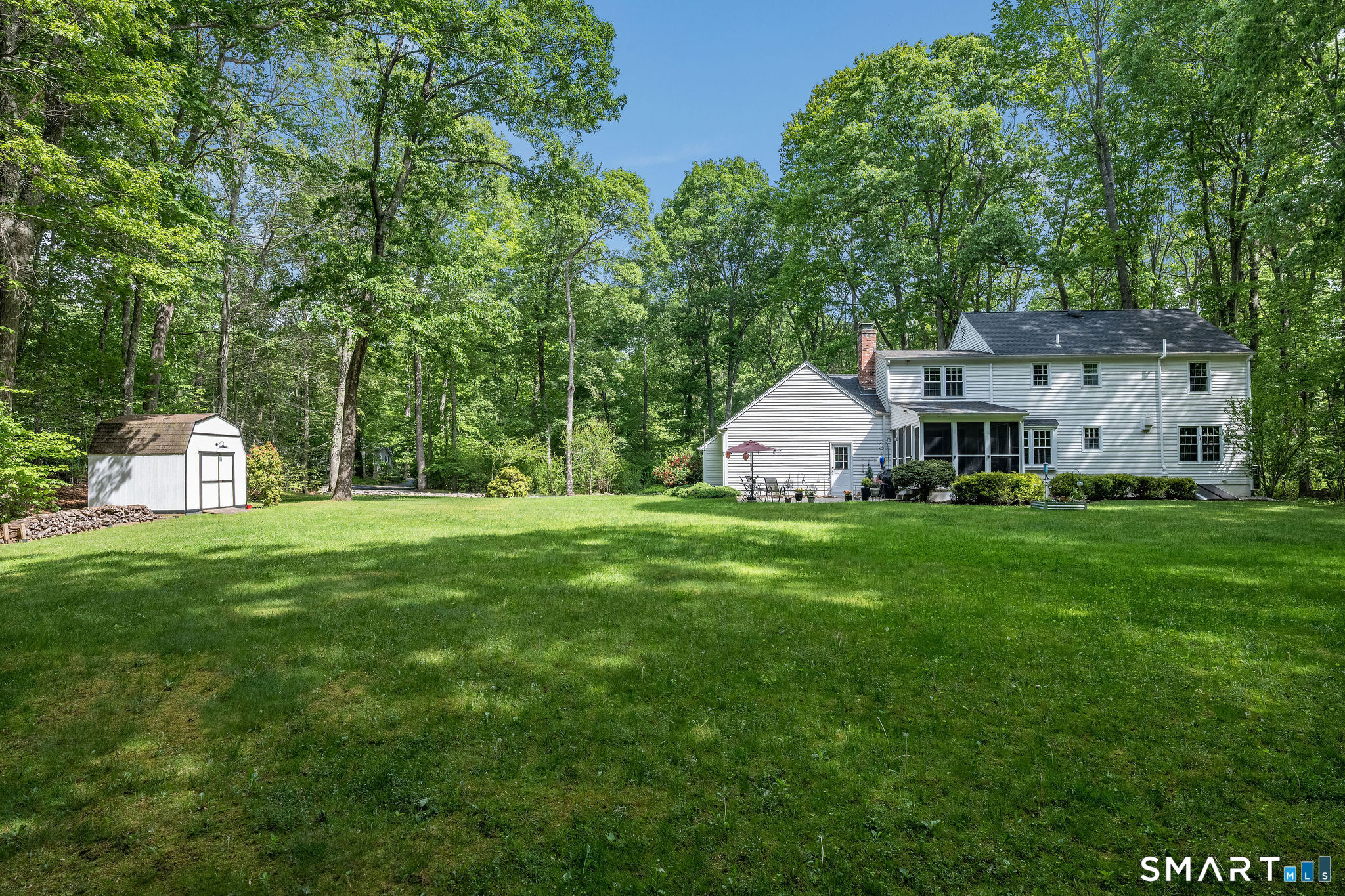 60 Bradley Corners Road Madison, CT 06443 - Photo 27 of 33 a front view of a house with garden and trees