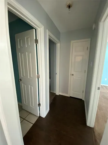 an entryway door with a hallway in the house