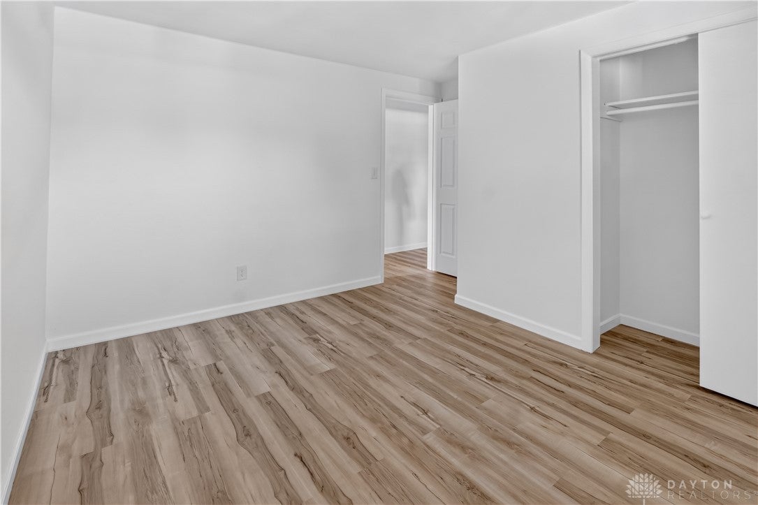 1243 Student Avenue Springfield, OH 45503 - Photo 22 of 38 Smooth plaster walls and warm wood-finish flooring define this versatile bedroom space.