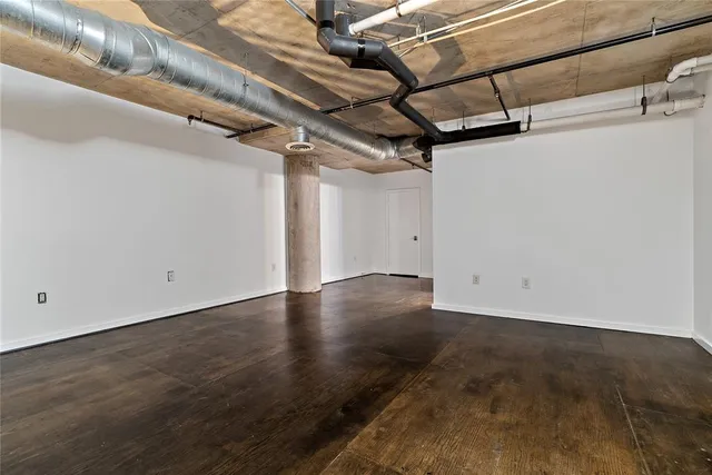 a view of a room with wooden floor