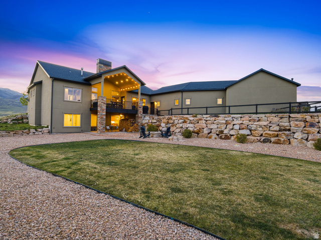 402 Shadow Hill Road Wanship, UT 84017 - Photo 77 of 90 Back of property with a balcony, a chimney, and stucco siding