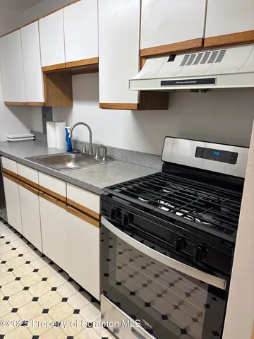 a kitchen with a refrigerator and a stove
