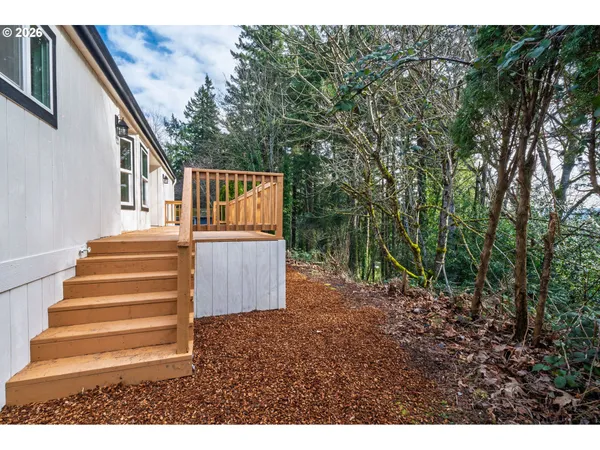 a backyard of a house with wooden floor and fence