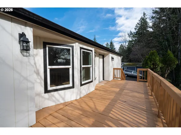 a view of house with backyard and deck
