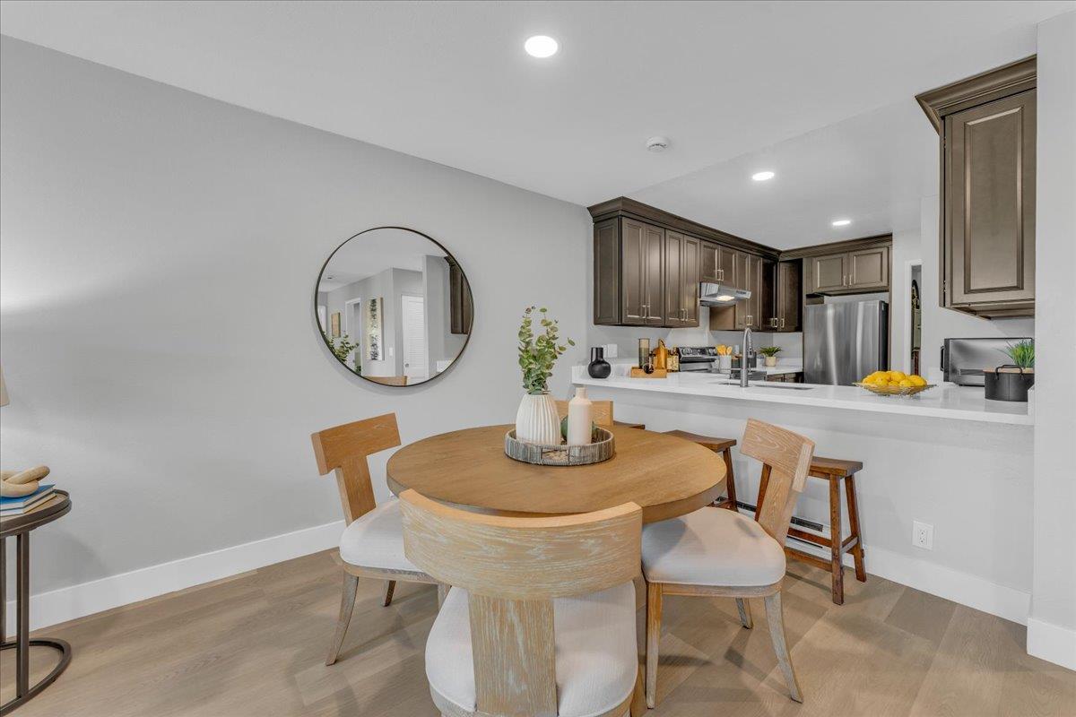 1685 Bayridge Way, Unit 204 San Mateo, CA 94402 - Photo 12 of 28 a kitchen with a dining table chairs and a refrigerator