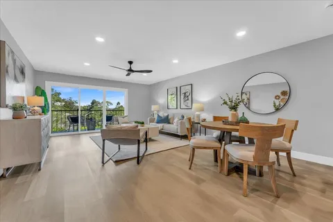a living room with furniture a rug and a large window