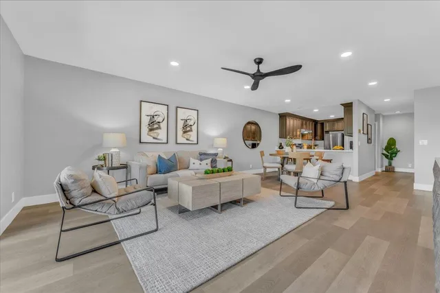 a living room with furniture and view of kitchen