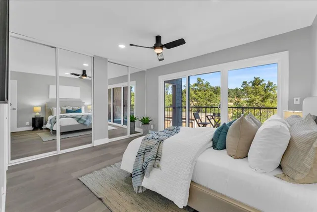 a bedroom with a large bed and a large window