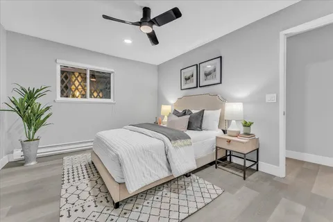 a bedroom with a bed and a painting on the wall