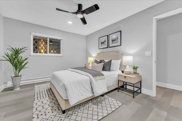 a bedroom with a bed and a painting on the wall