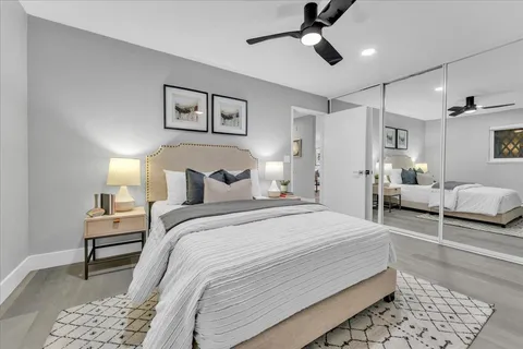 a bedroom with a bed and a chandelier