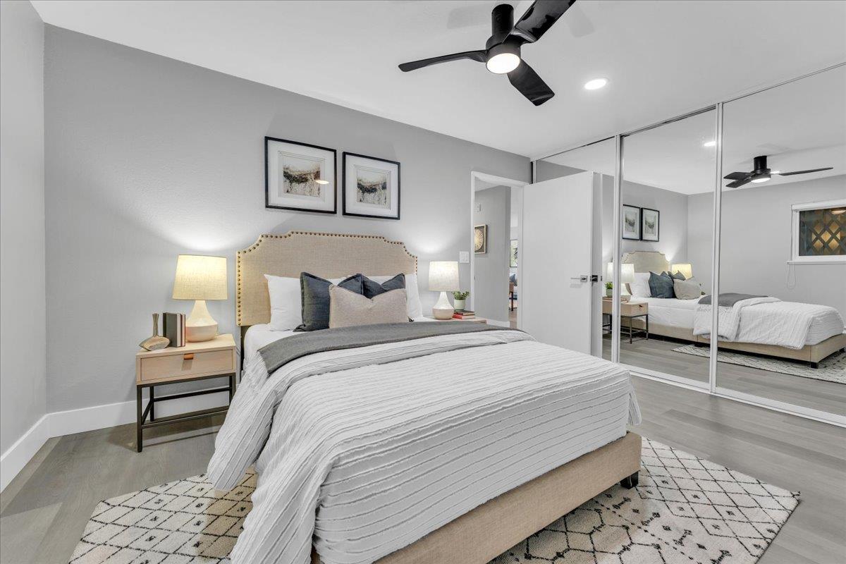 1685 Bayridge Way, Unit 204 San Mateo, CA 94402 - Photo 26 of 28 a bedroom with a bed and a chandelier