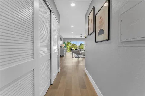 a view of a hallway with wooden floor