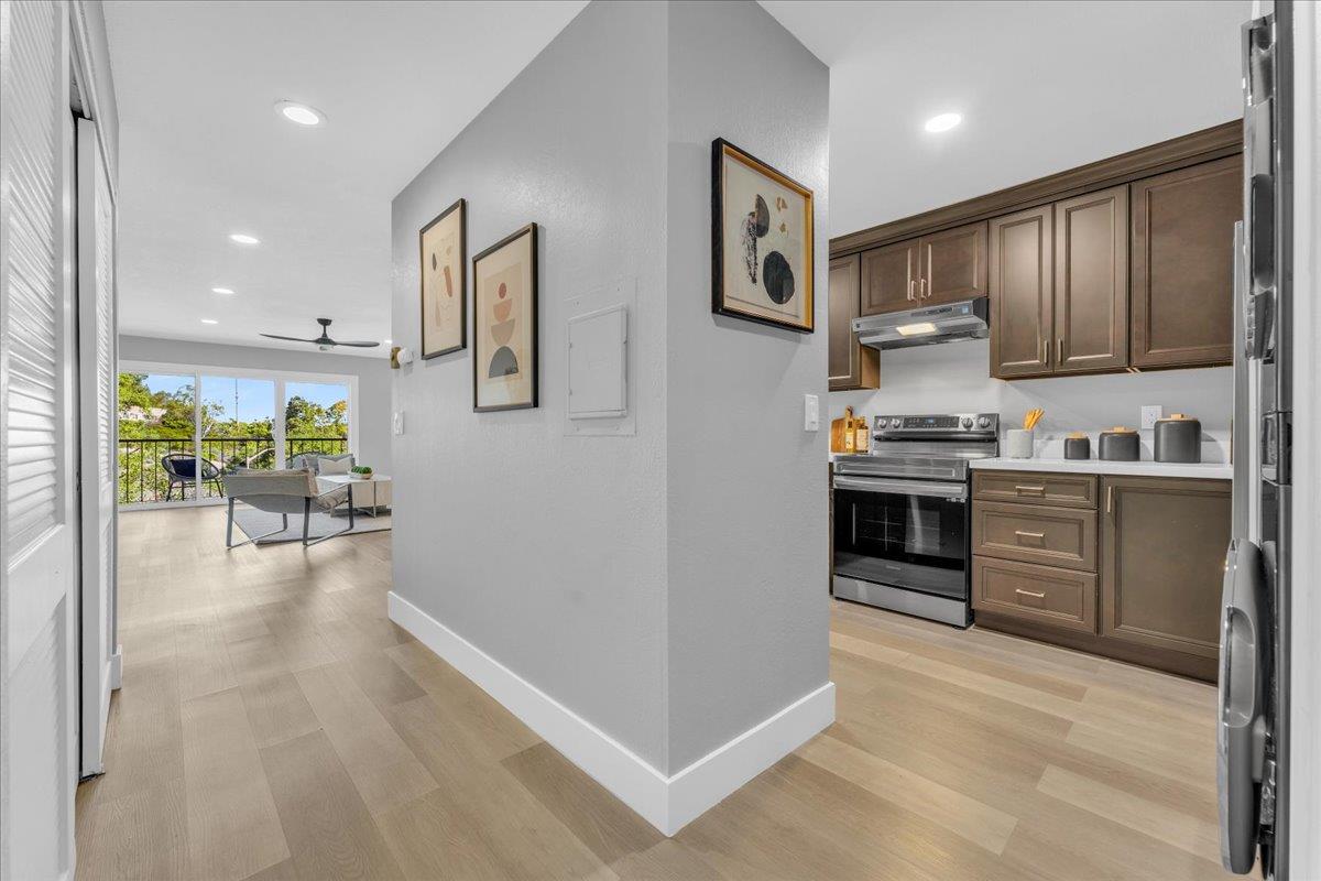 1685 Bayridge Way, Unit 204 San Mateo, CA 94402 - Photo 6 of 28 a kitchen with stainless steel appliances kitchen island granite countertop a refrigerator and a stove top oven