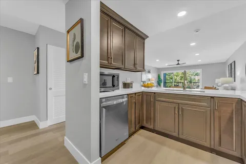 a kitchen with stainless steel appliances granite countertop a refrigerator and a sink
