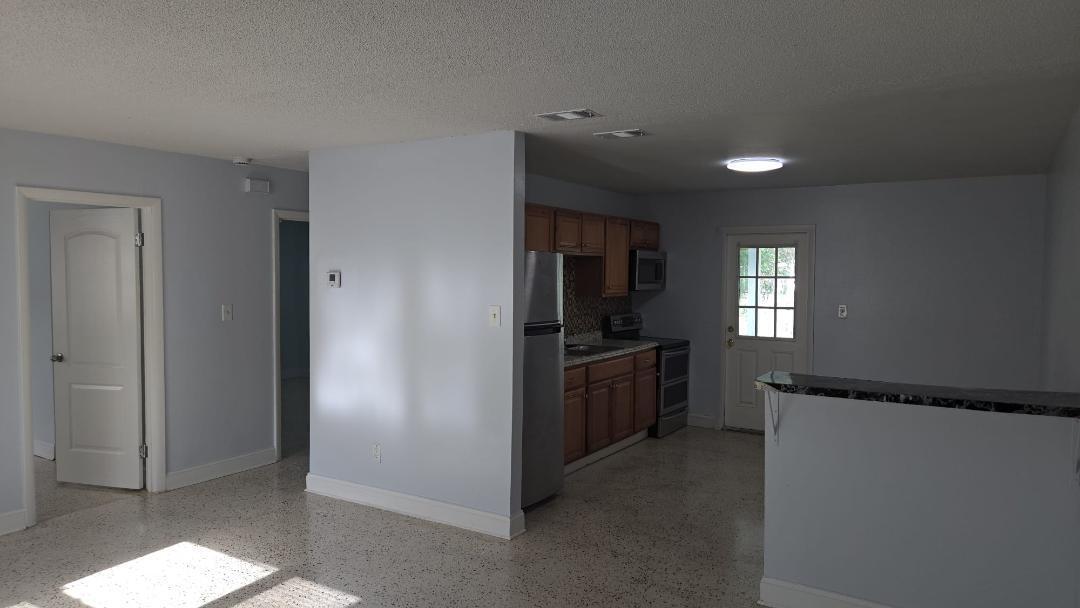 2736 Seneca Avenue Fort Pierce, FL 34946 - Photo 13 of 16 a view of a kitchen with refrigerator and windows