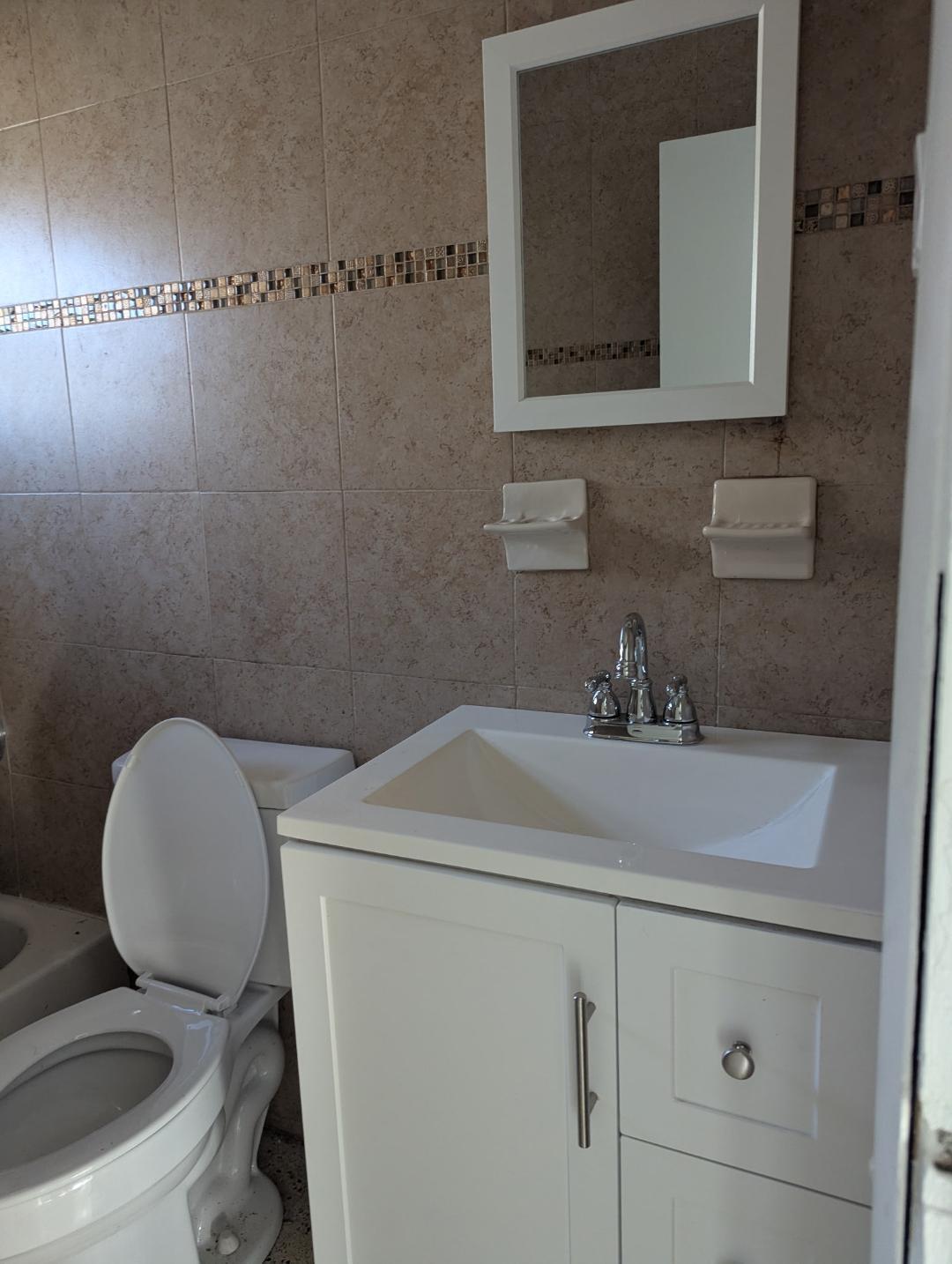 2736 Seneca Avenue Fort Pierce, FL 34946 - Photo 3 of 16 a bathroom with a sink toilet and mirror