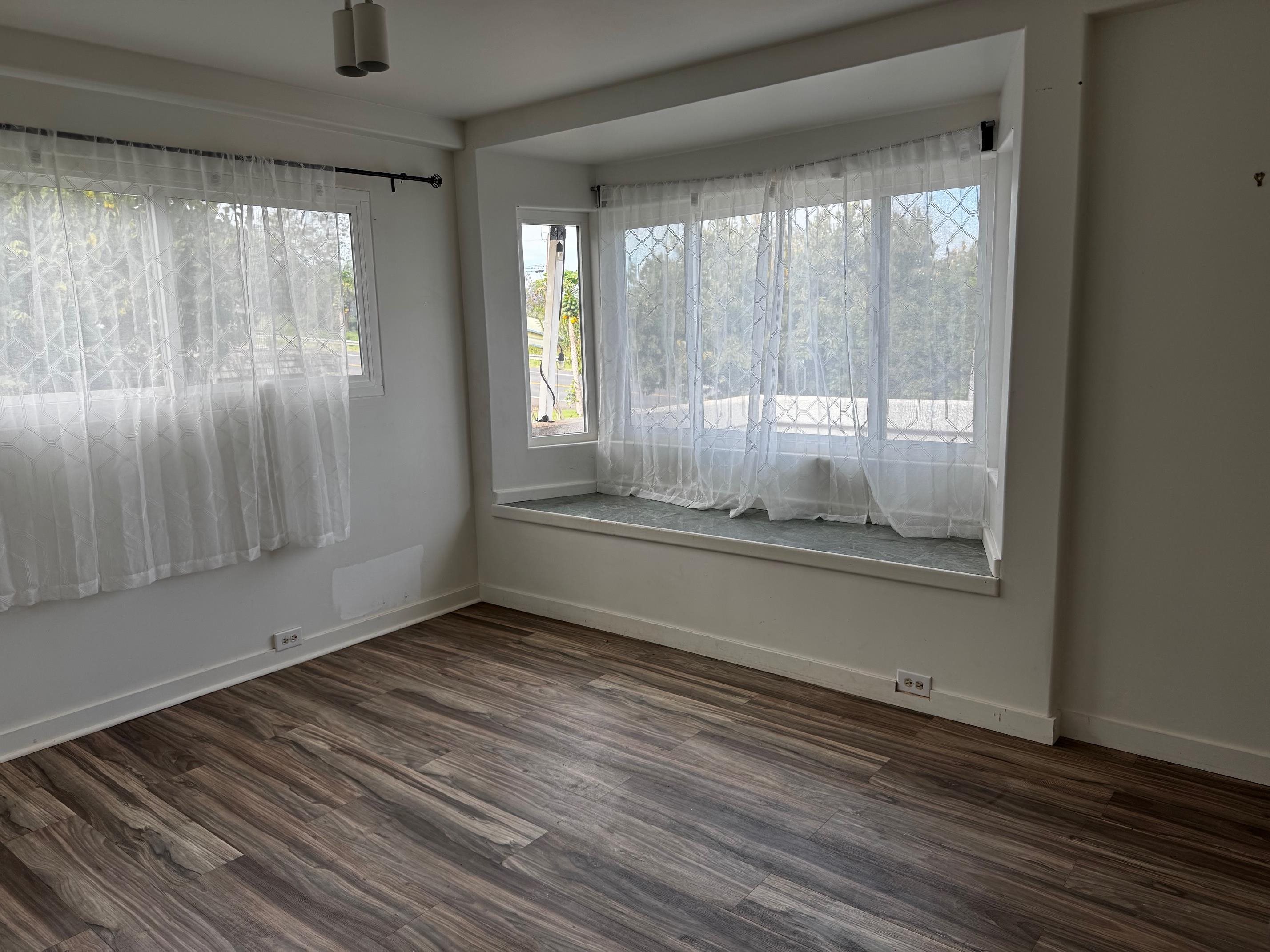 40 Kalihi Place Kula, HI 96790 - Photo 6 of 15 an empty room with wooden floor and windows