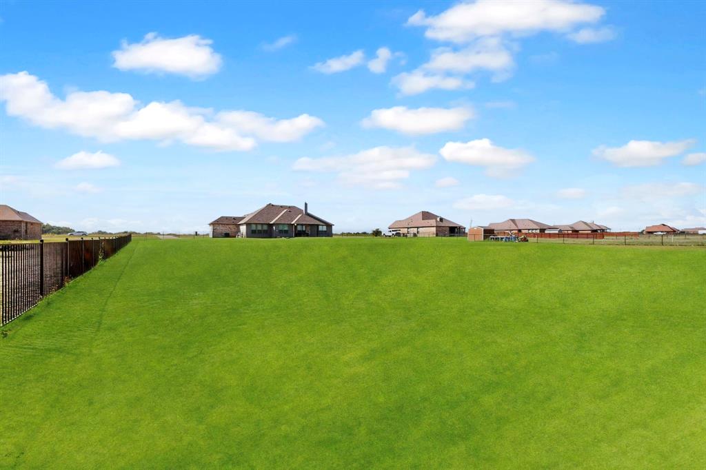 634 Gant Road Sherman, TX 75090 - Photo 30 of 40 Expansive grass lot featuring a black metal and wood privacy fence