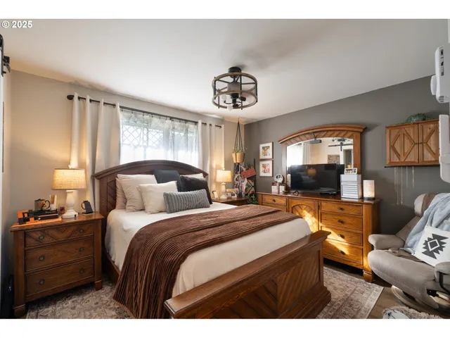 a bedroom with a bed and a chair