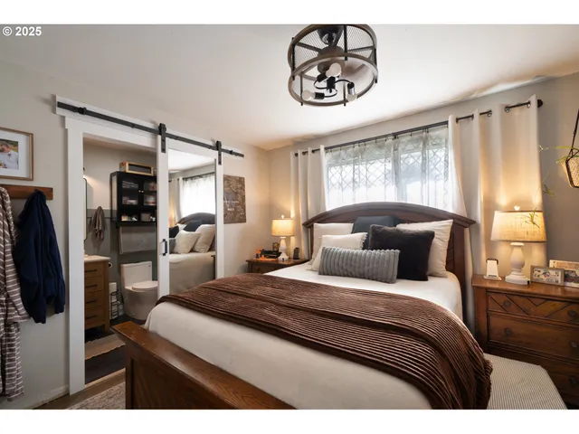 a bedroom with a large bed and a chandelier