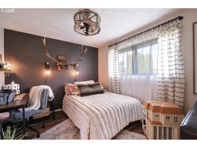 a bedroom with a bed and glass windows
