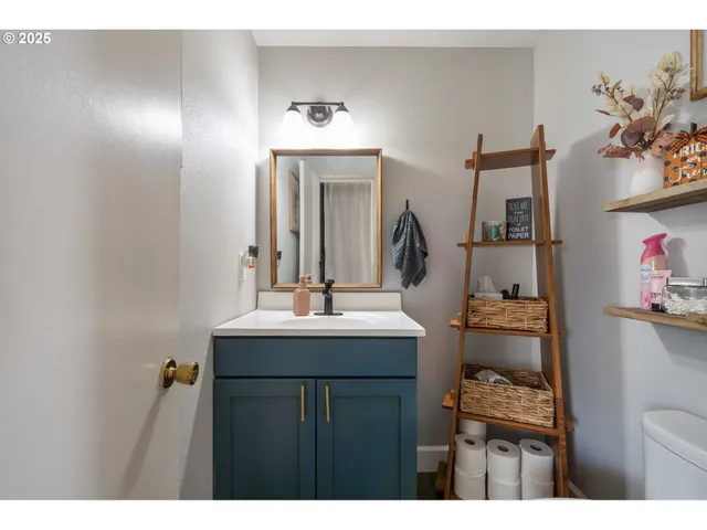 a bathroom with a sink vanity and a mirror