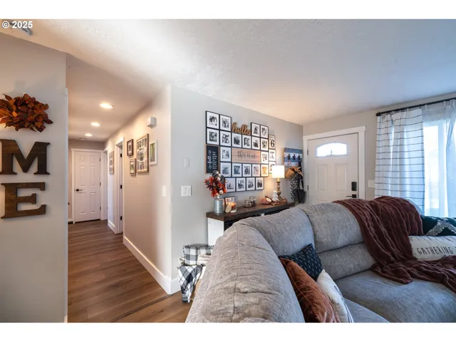 a living room with furniture and a book shelf