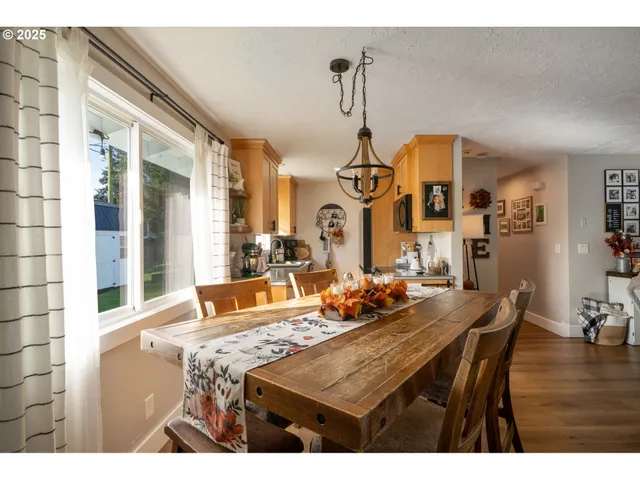 a dining room with furniture and wooden floor