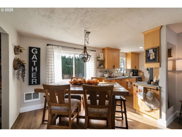 a view of a dining room with furniture and chandelier