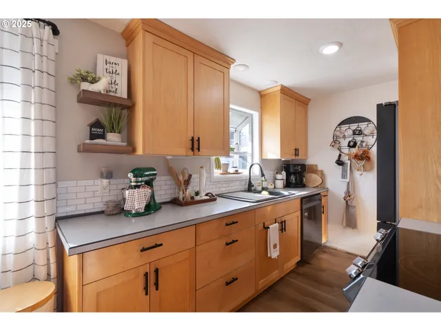 a kitchen with stainless steel appliances granite countertop a sink stove and cabinets