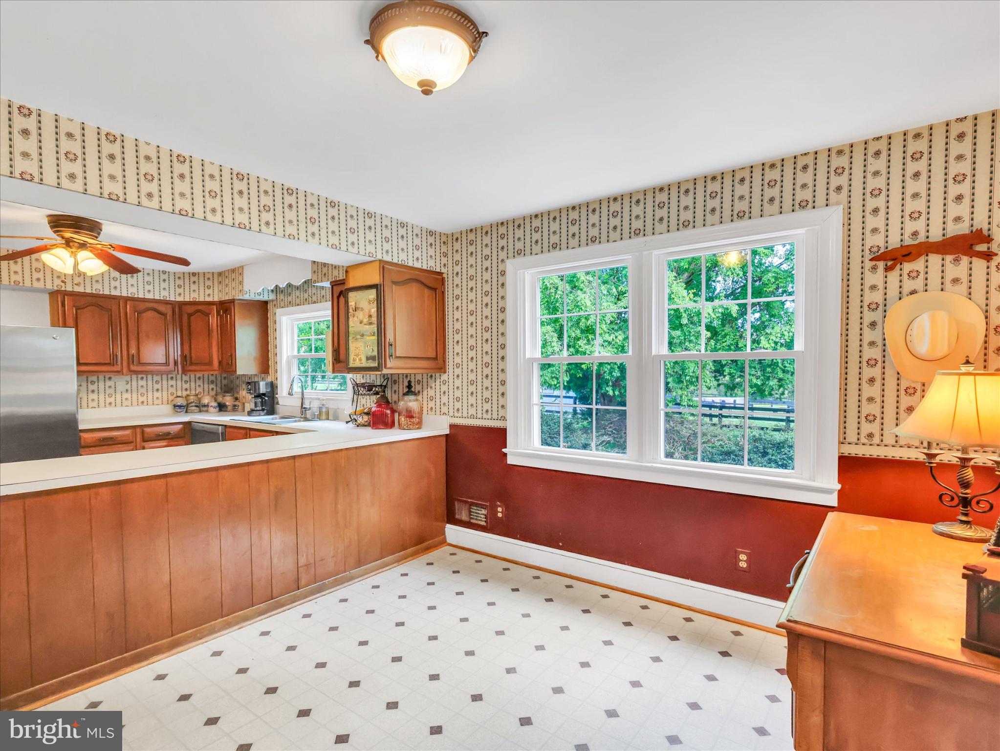 19255 Telegraph Springs Road Purcellville, VA 20132 - Photo 16 of 107 a large kitchen with kitchen island granite countertop a large window and a sink