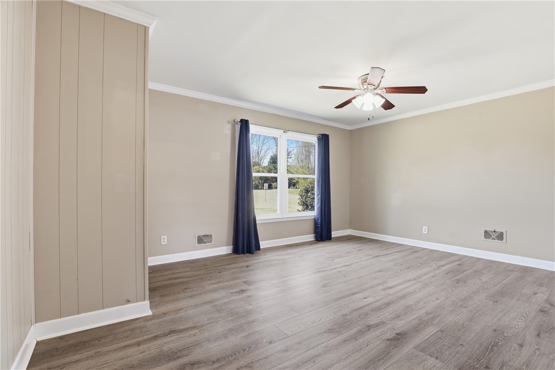 4304 Old Buncombe Road Greenville, SC 29617 - Photo 13 of 50 This airy room features durable flooring and a refreshing ceiling fan.