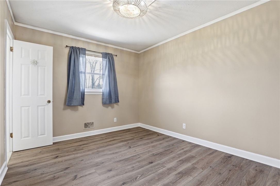 4304 Old Buncombe Road Greenville, SC 29617 - Photo 20 of 50 This spacious room features ample natural light and durable flooring, offering versatile design possibilities.