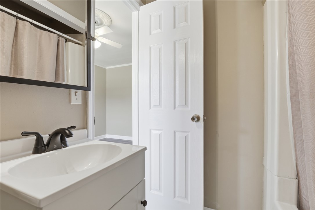 4304 Old Buncombe Road Greenville, SC 29617 - Photo 25 of 50 This clean and inviting bathroom features a single vanity and a shower-tub combination.