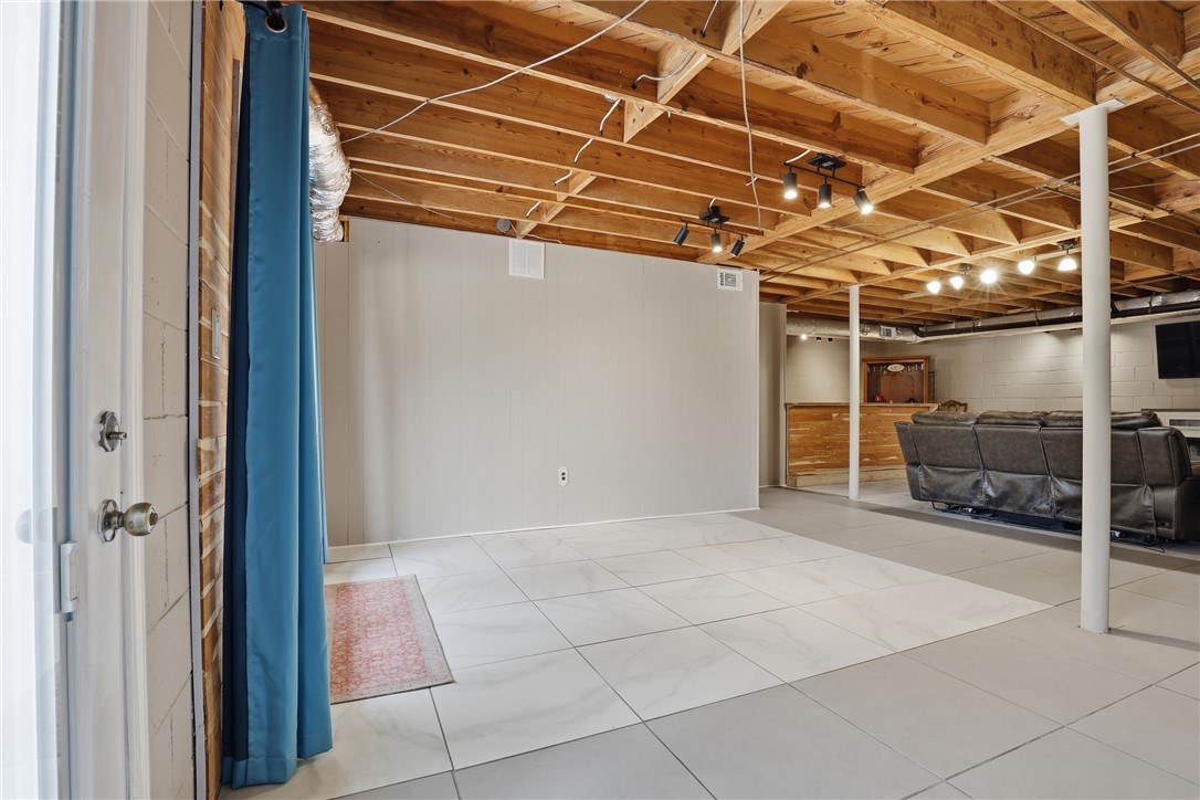4304 Old Buncombe Road Greenville, SC 29617 - Photo 28 of 50 This versatile basement offers ample space and a blend of tile and concrete flooring.