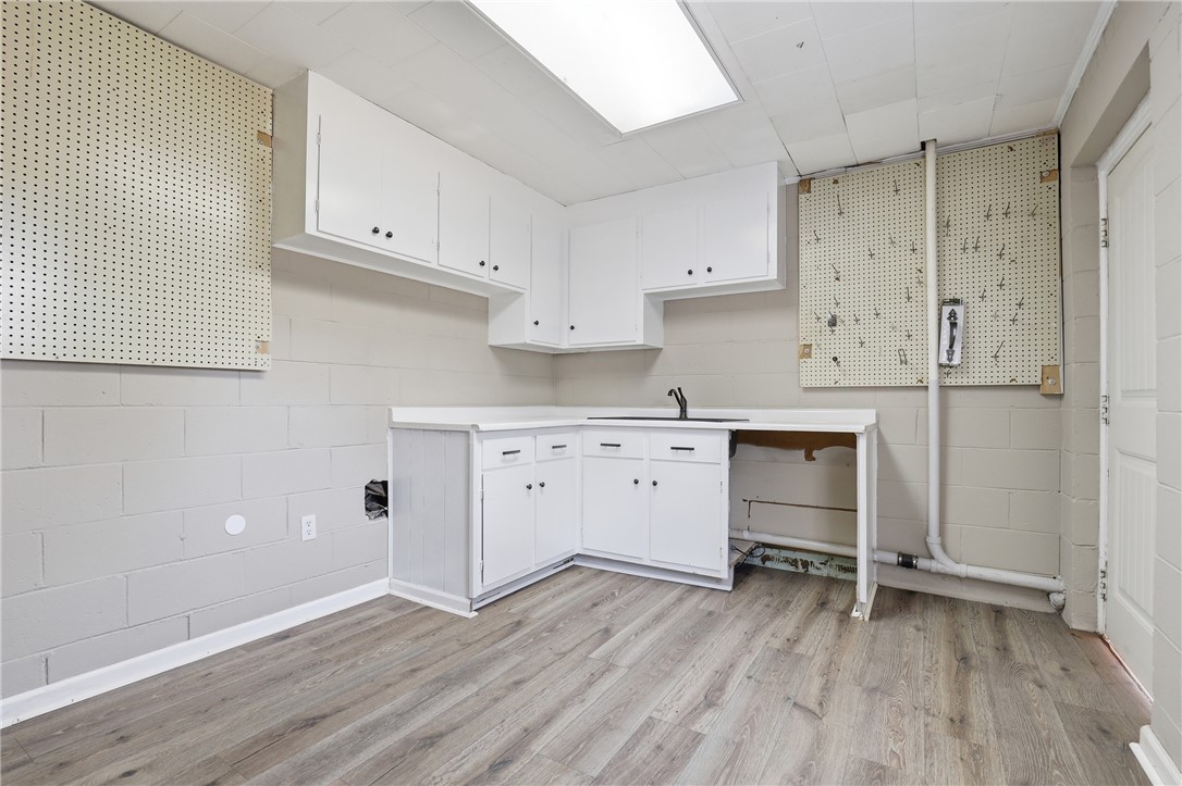 4304 Old Buncombe Road Greenville, SC 29617 - Photo 38 of 50 This spacious utility area offers practical cabinetry and durable flooring, perfect for daily tasks.