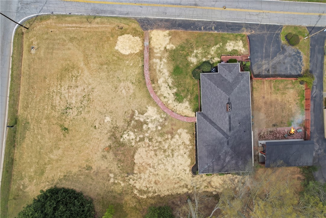 4304 Old Buncombe Road Greenville, SC 29617 - Photo 46 of 50 This spacious property features ample yard space, a paved driveway, and a charming fire pit.