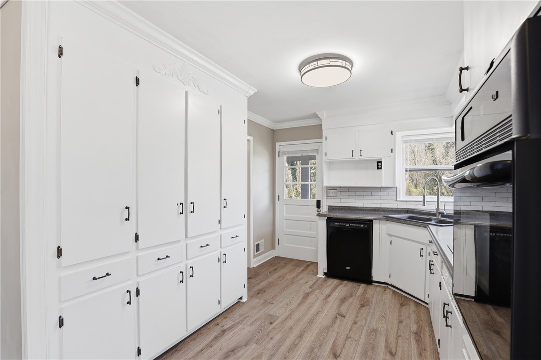 4304 Old Buncombe Road Greenville, SC 29617 - Photo 10 of 50 Bright and airy, this kitchen features ample storage and a charming backyard view.