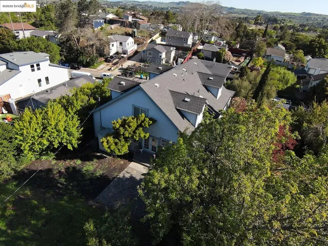 an aerial view of a house with a yard and lake view