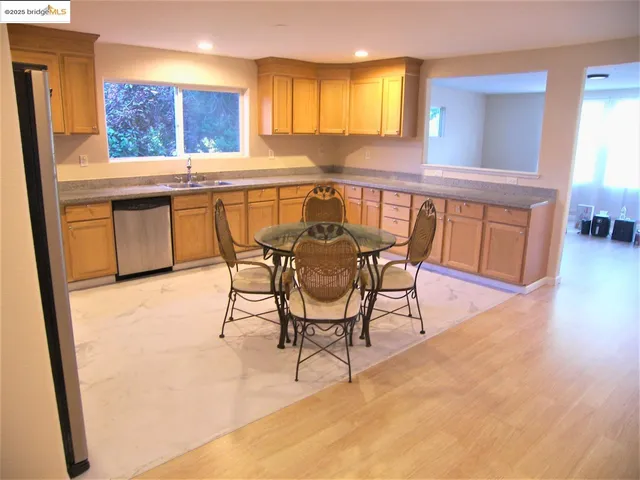 a view of a kitchen with a table and chairs