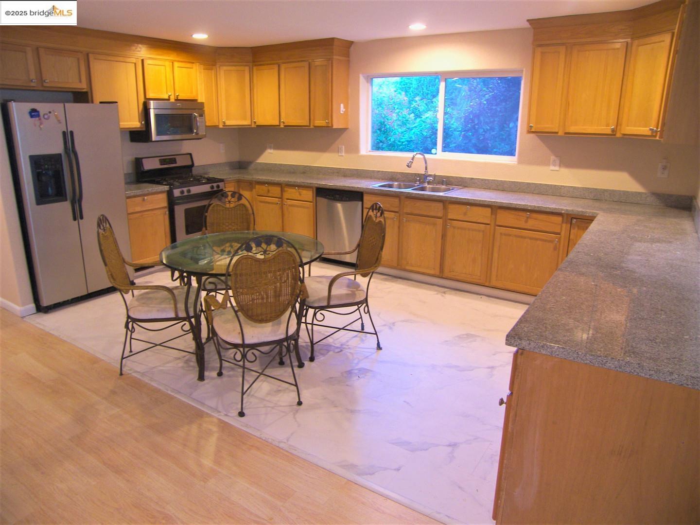 1259 Fulton Avenue Vallejo, CA 94591 - Photo 12 of 28 a kitchen with stainless steel appliances a stove a sink a microwave a refrigerator and chairs