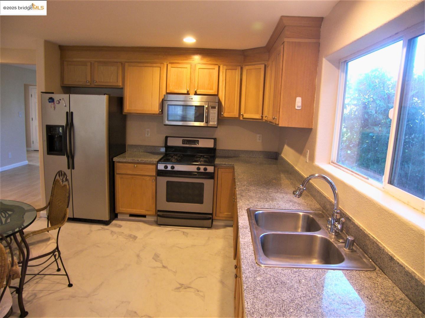 1259 Fulton Avenue Vallejo, CA 94591 - Photo 13 of 28 a kitchen with stainless steel appliances granite countertop a sink stove and refrigerator