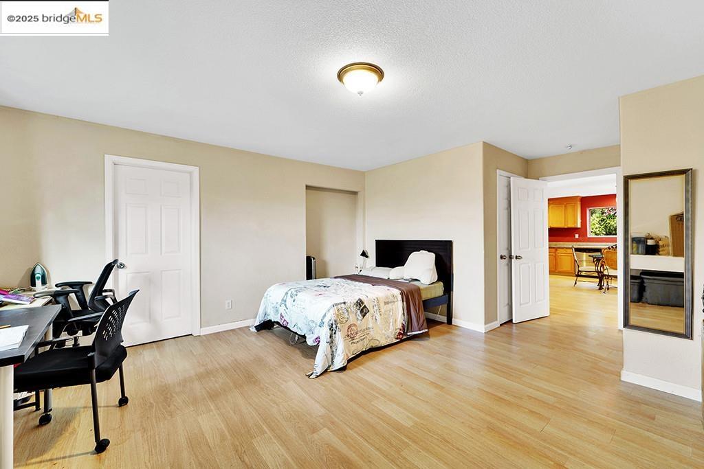 1259 Fulton Avenue Vallejo, CA 94591 - Photo 18 of 28 a spacious bedroom with a bed and wooden floor