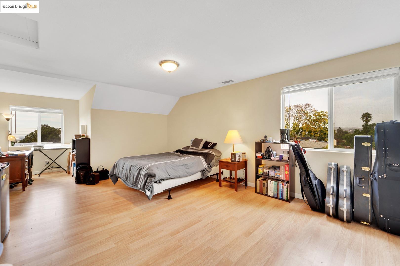 1259 Fulton Avenue Vallejo, CA 94591 - Photo 24 of 28 a spacious bedroom with a bed a table and a large window