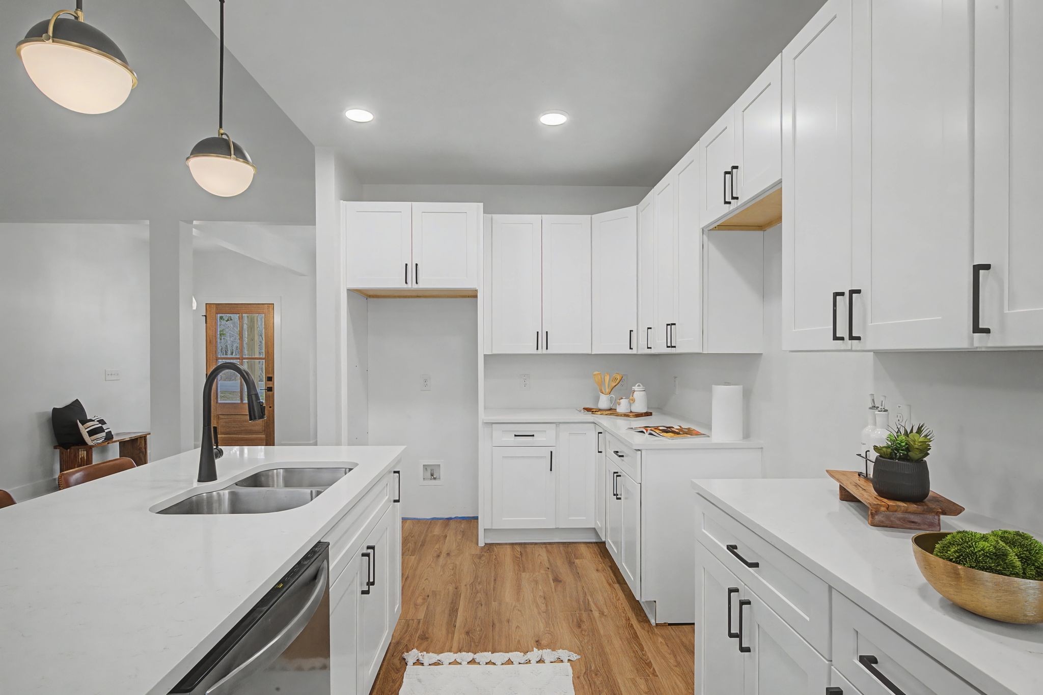 1171 Old Charlotte Road White Bluff, TN 37187 - Photo 15 of 29 a kitchen with a sink dishwasher stove and white cabinets with wooden floor