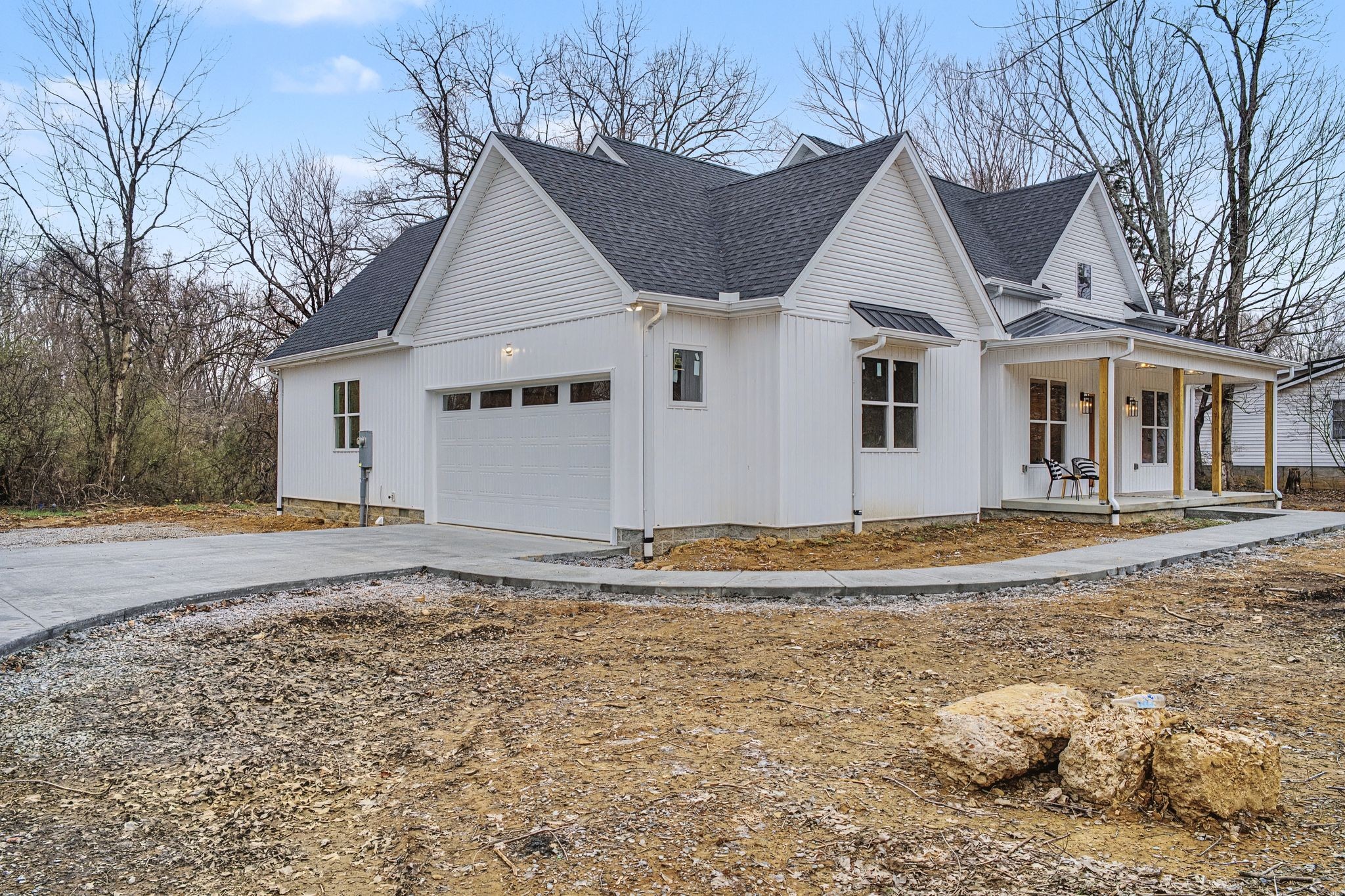 1171 Old Charlotte Road White Bluff, TN 37187 - Photo 2 of 29 a view of a white house with a yard covered with large trees