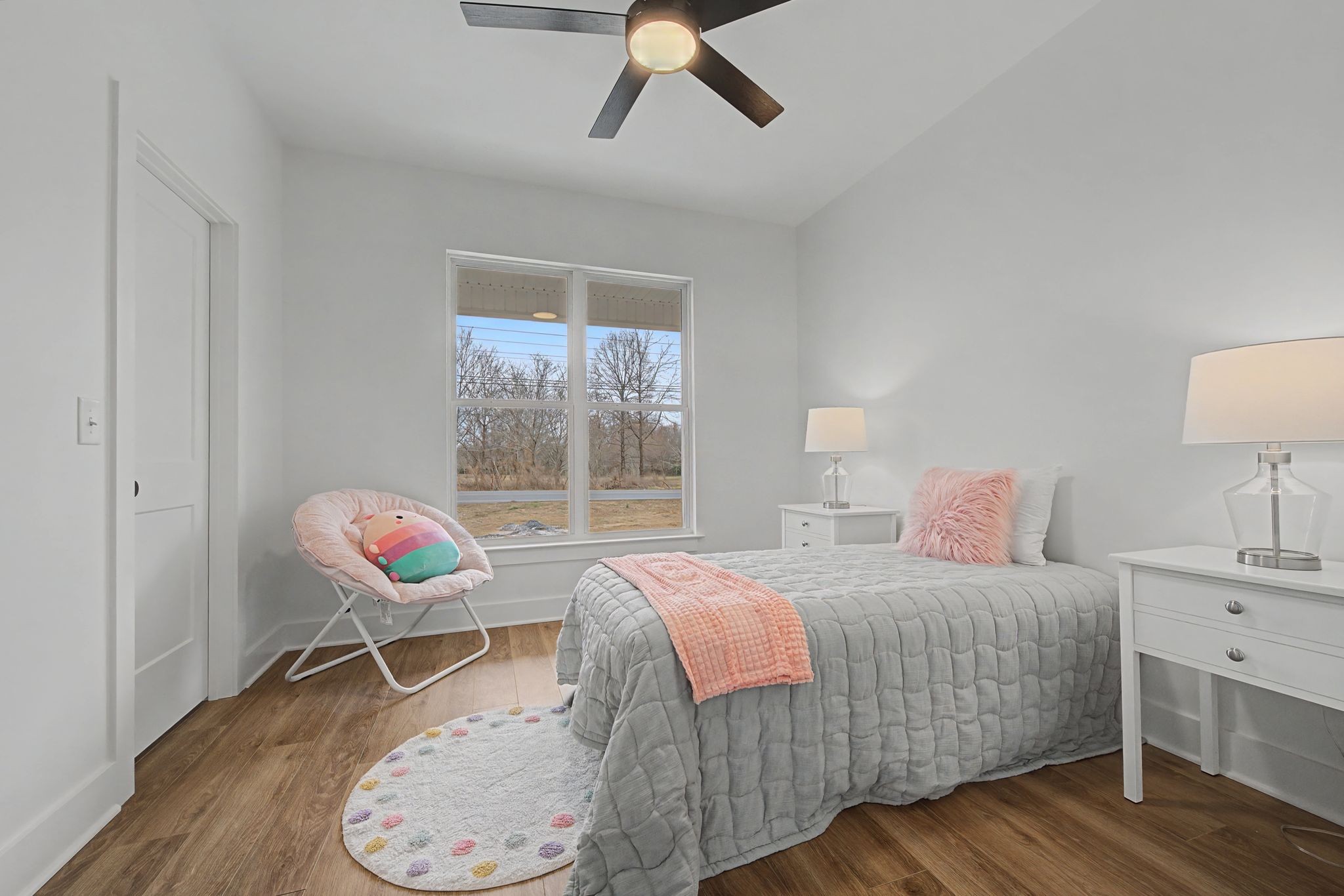 1171 Old Charlotte Road White Bluff, TN 37187 - Photo 24 of 29 a bedroom with a bed a chair and a chandelier