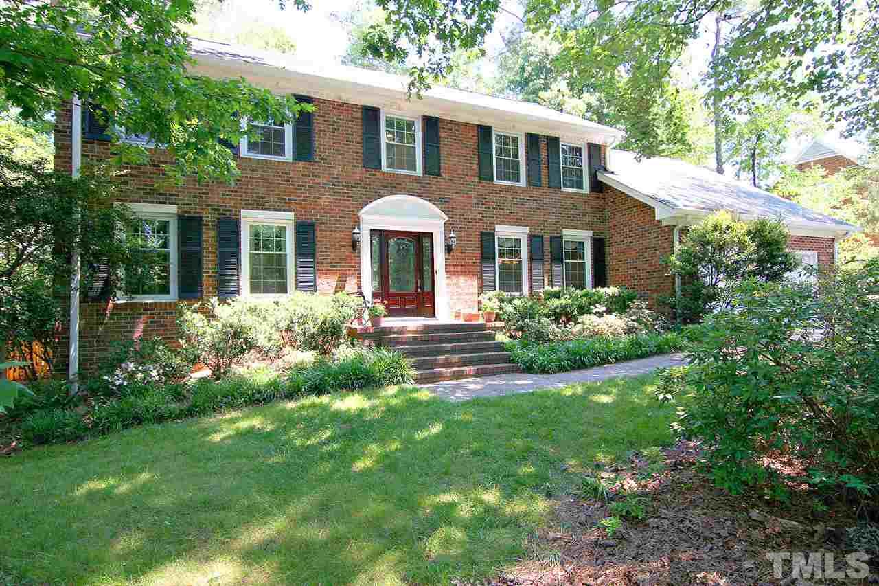 218 Queensferry Road Cary, NC 27511 - Photo 2 of 25 a front view of a house with a garden and plants